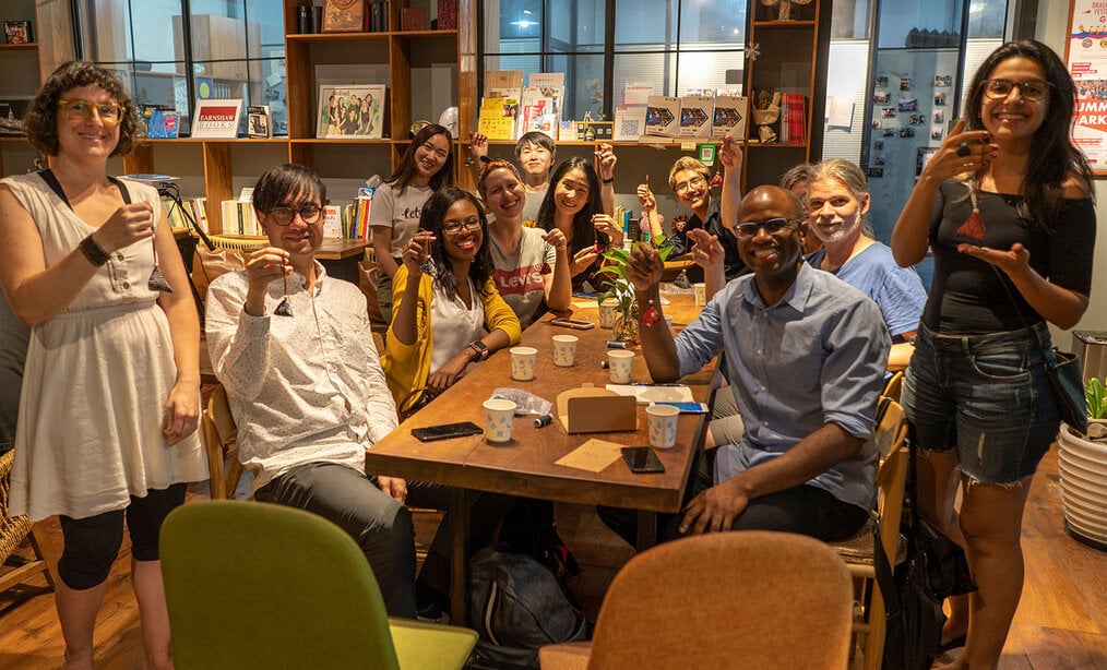 Lynda E., GoEast Shanghai A group of teachers hold up a craft project.